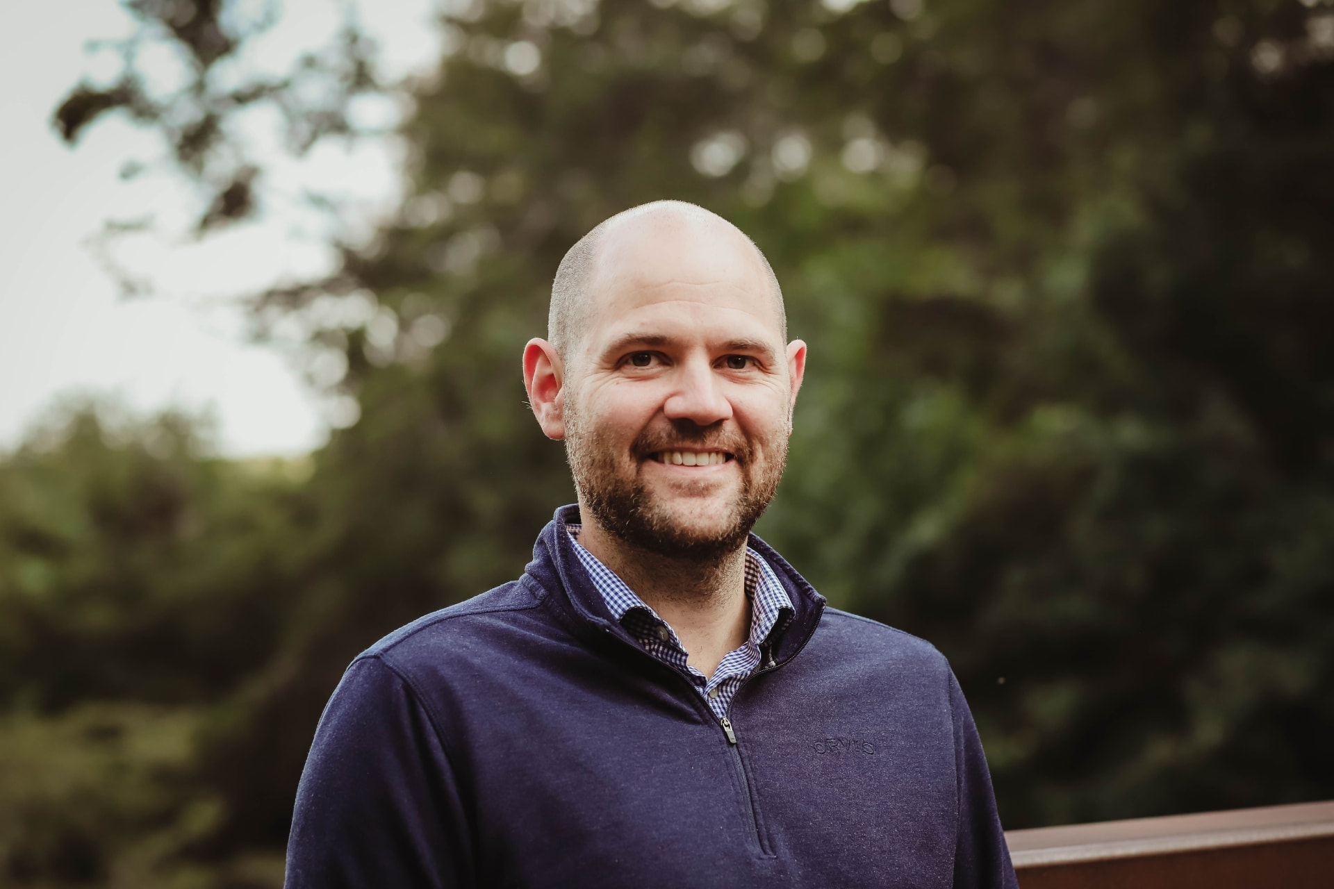 John Hausman, Founder and CEO of Haus, outdoors among trees